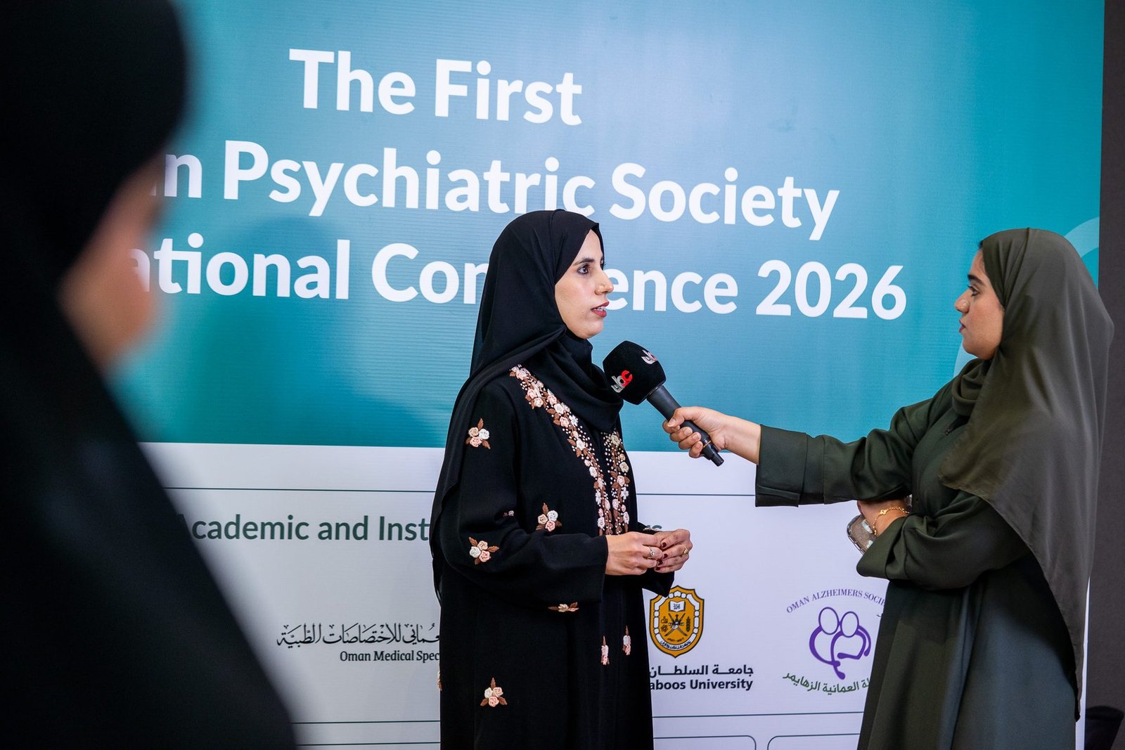 A national television interview in front of the OPS2026 conference backdrop